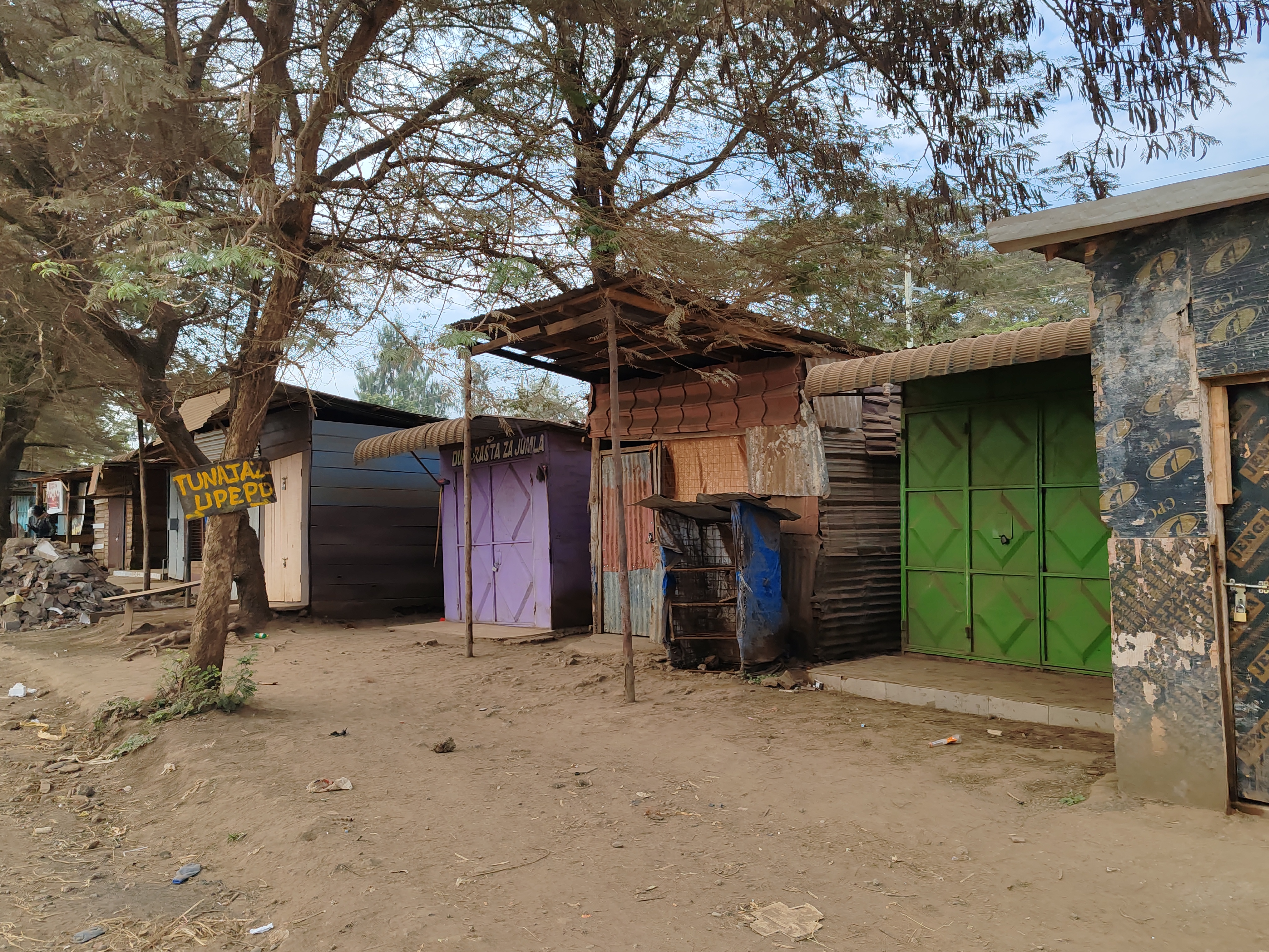 Road with closed shops in multi-colored jails in Arusha, Tanzania